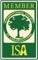 A green and white sign with a tree in the middle.